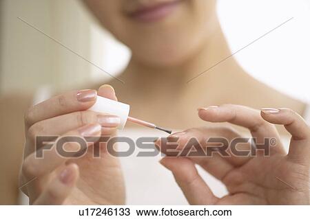 Young woman polishing nails, close up View Large Photo Image Stock Image - Young woman polishing nails, close up. Fotosearch