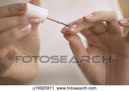 Young woman polishing nails, close up View Large Photo Image Stock Image - Young woman polishing nails, close up. Fotosearch