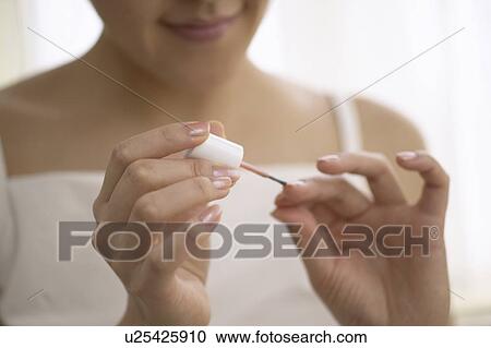 Young woman polishing nails, close up View Large Photo Image Stock Image - Young woman polishing nails, close up. Fotosearch