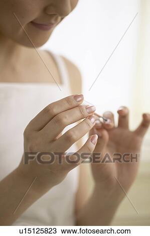 Young woman polishing nails View Large Photo Image Stock Image - Young woman polishing nails. Fotosearch