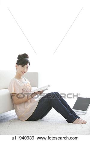 Young woman reading a book View Large Photo Image Stock Photo - Young woman reading a book. Fotosearch