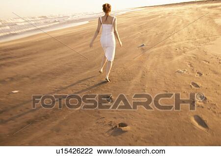 Young woman running on beach View Large Photo Image Stock Image - Young woman running on beach. Fotosearch