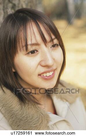 Young woman smiling View Large Photo Image Stock Image - Young woman smiling. Fotosearch
