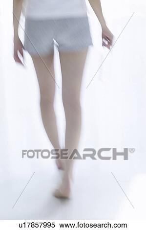 Young woman standing by window, holding bottle of water, soft focus View Large Photo Image Stock Photography - Young woman standing by window, holding bottle of water, soft focus. Fotosearch
