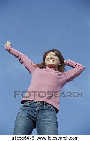 Young woman stretching outdoors View Large Photo Image Stock Photograph - Young woman stretching outdoors. Fotosearch