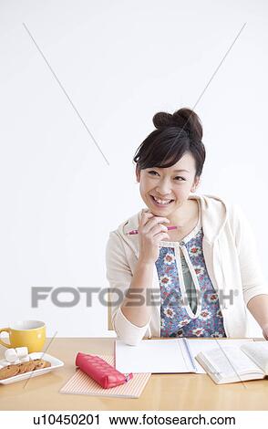 Stock Image - Young woman studying. Fotosearch