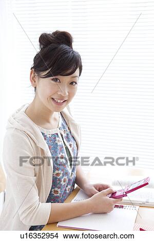 Young woman text messaging View Large Photo Image Picture - Young woman text messaging. Fotosearch
