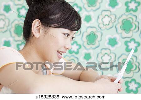 Young woman text messaging View Large Photo Image Stock Photography - Young woman text messaging. Fotosearch