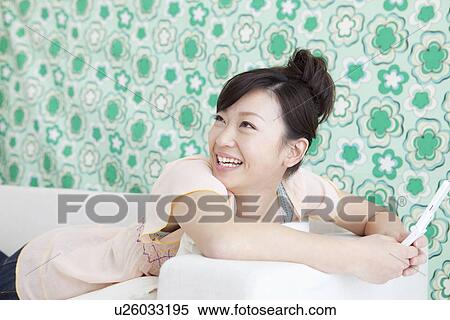 Stock Photography - Young woman text messaging. Fotosearch
