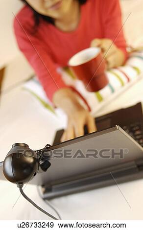 Stock Photo - Young woman using laptop. Fotosearch