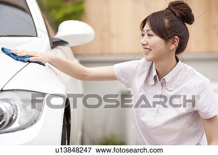 Young woman washing car, smiling View Large Photo Image Stock Photo - Young woman washing car, smiling. Fotosearch
