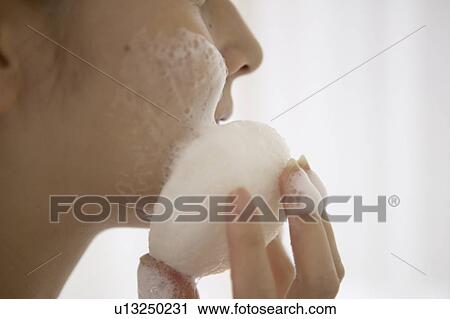Young woman washing face, close up View Large Photo Image Stock Image - Young woman washing face, close up. Fotosearch