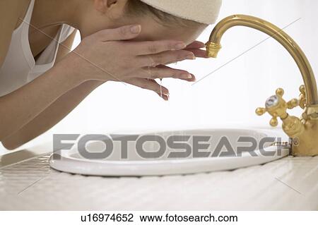 Young woman washing face View Large Photo Image Stock Image - Young woman washing face. Fotosearch
