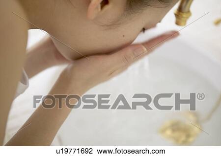 Young woman washing face View Large Photo Image Stock Image - Young woman washing face. Fotosearch