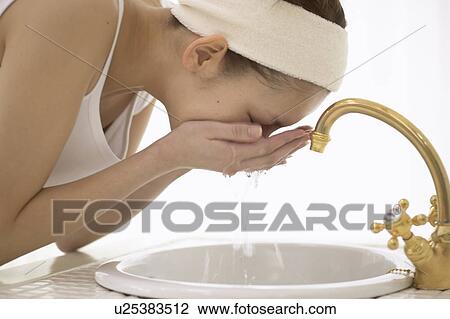 Young woman washing face View Large Photo Image Stock Image - Young woman washing face. Fotosearch