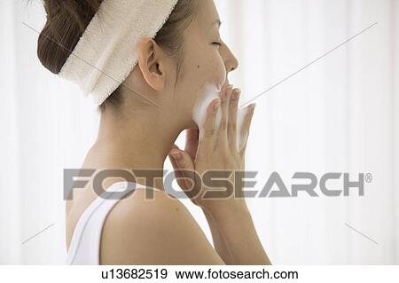 Young woman washing face View Large Photo Image Stock Photo - Young woman washing face. Fotosearch