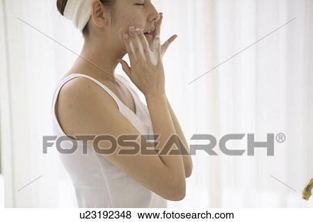 Stock Photo - Young woman washing face. Fotosearch