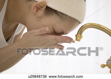 Young woman washing face View Large Photo Image Stock Photo - Young woman washing face. Fotosearch