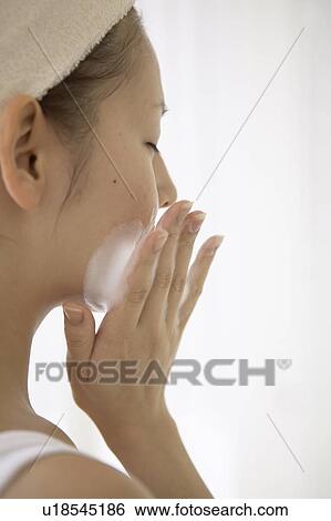 Stock Photograph - Young woman washing face. Fotosearch