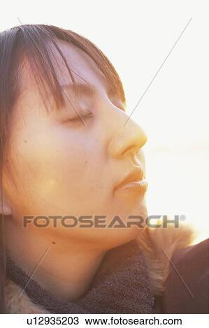 Young woman with her eyes closed View Large Photo Image Stock Image - Young woman with her eyes closed. Fotosearch