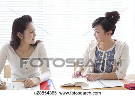 Young women studying together View Large Photo Image Stock Photography - Young women studying together. Fotosearch