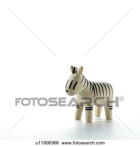 Stock Photograph - Zebra figurine on white background, copy space. Fotosearch