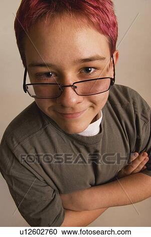 a boy with red hair and eye glasses sliding down his nose View Large Photo Image Stock Image - a boy with red hair and eye glasses sliding down his nose. Fotosearch