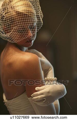 a bride wearing a strapless dress, veil and white gloves View Large Photo Image Stock Photo - a bride wearing a strapless dress, veil and white gloves. Fotosearch
