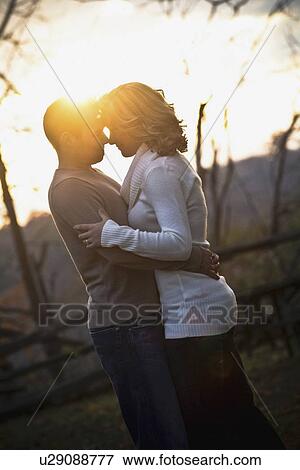 a couple standing in an embrace View Large Photo Image Stock Photo - a couple standing in an embrace. Fotosearch