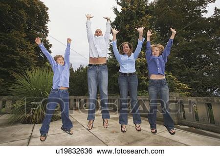 Stock Photograph - a family jumping in the air together. Fotosearch