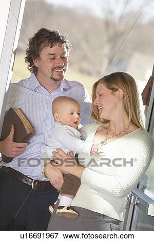 a family with a baby boy and the father holding a bible View Large Photo Image Stock Photo - a family with a baby boy and the father holding a bible. Fotosearch
