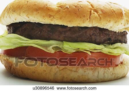 a hamburger with lettuce and tomato View Large Photo Image Stock Photograph - a hamburger with lettuce and tomato. Fotosearch