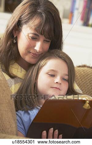 a mother and daughter read the bible together View Large Photo Image Stock Image - a mother and daughter read the bible together. Fotosearch