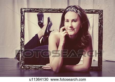 a woman with her upper body laying through a picture frame View Large Photo Image Stock Image - a woman with her upper body laying through a picture frame. Fotosearch