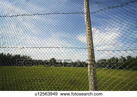 alberta, canada; a chain link fence attached to a wooden pole View Large Photo Image Stock Photo - alberta, canada; a chain link fence attached to a wooden pole. Fotosearch