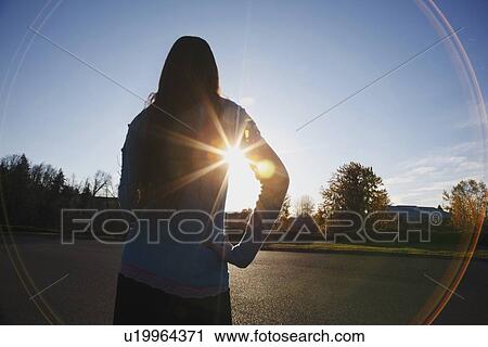 beams of sunlight and a circular glare around a teenage girl View Large Photo Image Stock Image - beams of sunlight and a circular glare around a teenage girl. Fotosearch