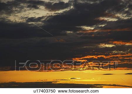 Stock Image - clouds at sunset. Fotosearch