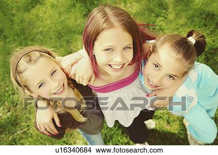 Picture - edmonton, alberta, canada; three girls in an embrace. Fotosearch