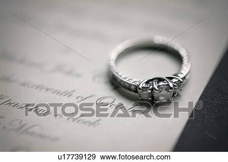 engagement ring on a wedding invitation View Large Photo Image Stock Photo - engagement ring on a wedding invitation. Fotosearch