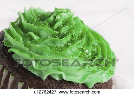 green icing on a chocolate cupcake for saint patrick's day View Large Photo Image Stock Photo - green icing on a chocolate cupcake for saint patrick's day. Fotosearch