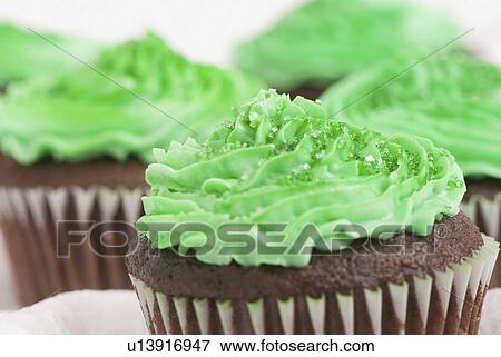 Stock Photo - green icing on chocolate cupcakes for saint patrick's day. Fotosearch