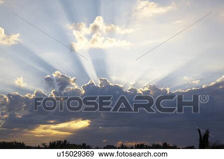 Stock Photo - guatemala city, guatemala; sunlight breaks through the clouds. Fotosearch
