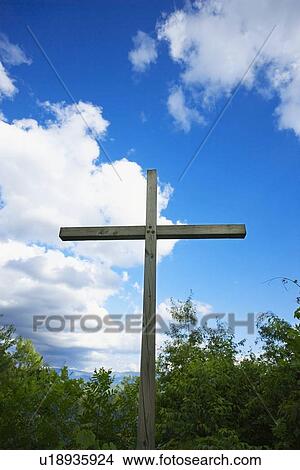 Picture - knoxville, tennessee, united states of america; a cross against a blue sky with clouds. Fotosearch