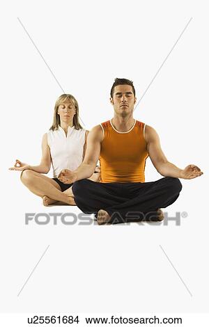 Picture - man and woman in a yoga pose. Fotosearch