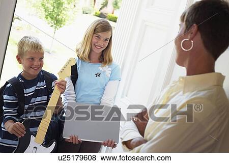 Stock Photo - mother greeting children at the door as they're coming home from school. Fotosearch