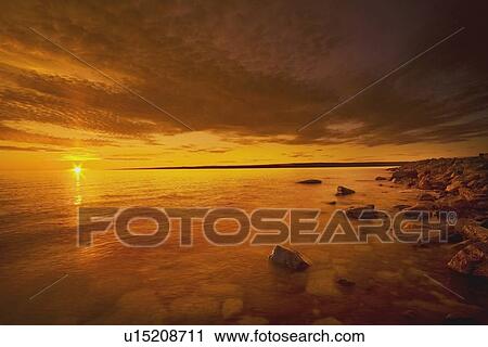 Stock Image - northwest territories, canada; coastline of the arctic ocean at sunset. Fotosearch
