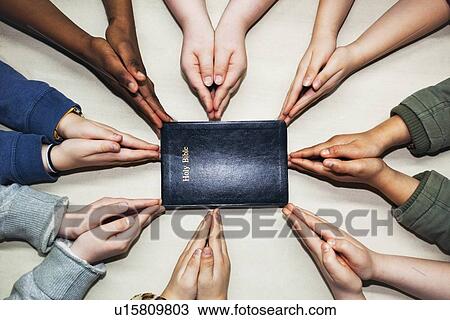 praying hands pointing to a bible View Large Photo Image Stock Image - praying hands pointing to a bible. Fotosearch