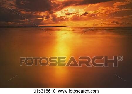 Stock Image - slave lake, alberta, canada; sunset over a lake. Fotosearch