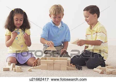 three children building noah's ark with wooden blocks View Large Photo Image Stock Photo - three children building noah's ark with wooden blocks. Fotosearch
