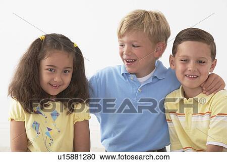 Stock Image - three children in an embrace. Fotosearch